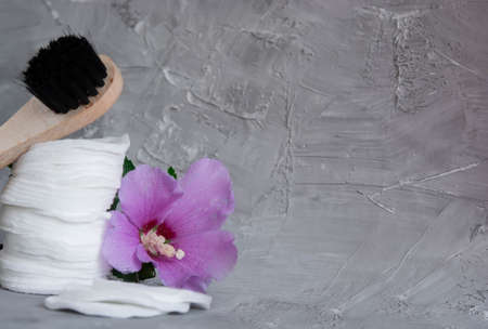 Dry massage brush close-up, cotton pads, cotton buds, blue cotton buds, make-up remover pads, lilac...