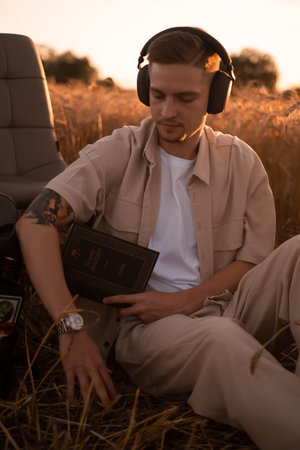 man holding up Bible in a wheat field