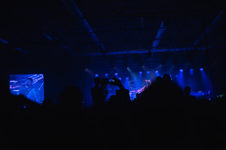 rock concert, music festival, New Year celebration, nightclub party, dance floor, disco club, many people standing with their hands up and clapping, happiness and nightlife conceptの写真素材