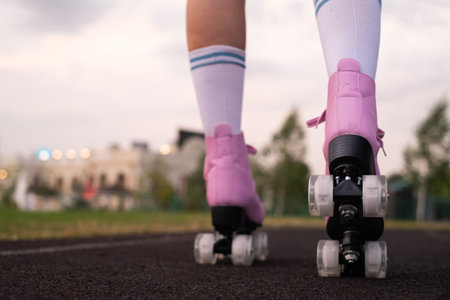 Close-up of an unknown man roller skating in the park on a sunny day, being on the road, spending...