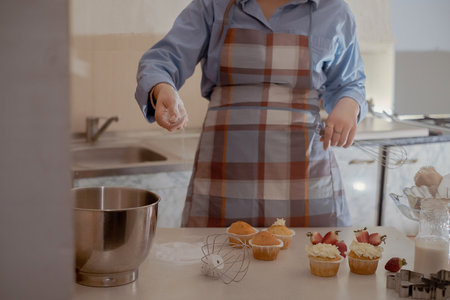A female pastry chef prepares dough, sprinkling flour, showcasing homemade baking. Explore the charm...