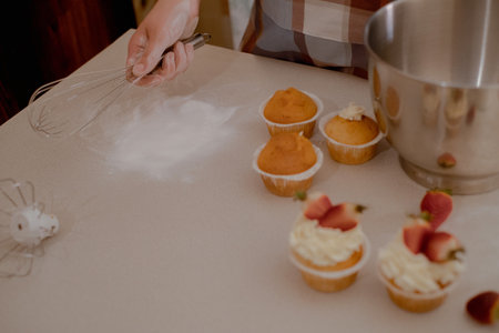 A female pastry chef prepares dough, sprinkling flour, showcasing homemade baking. Explore the charm...