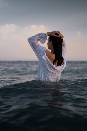 Girl swims in the sea, epitomizing calmness and relaxation. Promotes tourism, resorts, healthy...