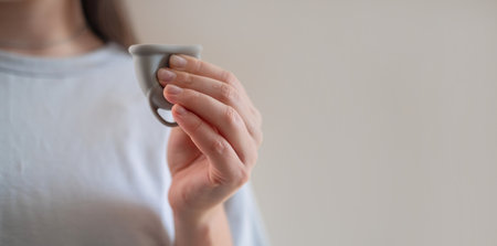 Woman holding a menstrual cup, eco-friendly and biodegradable organic hygiene products.の写真素材