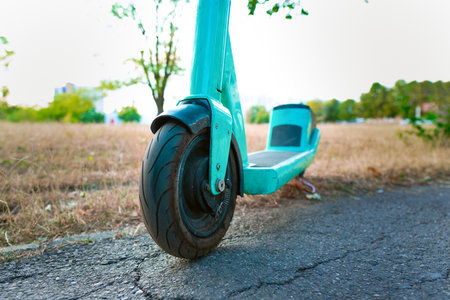 Electric scooter in an urban area. Promoting e-scooters as eco-friendly alternatives to cars and public transport, reducing carbon emissions.の写真素材