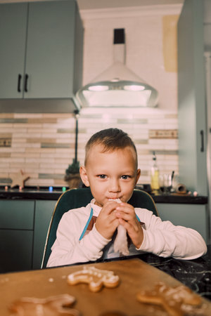 A mother and her children cook together in the kitchen, highlighting how cooking helps develop essential skills in kids.の写真素材