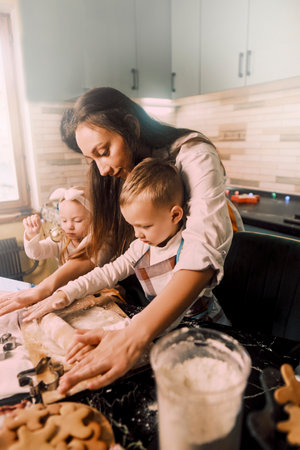 Mom and kids cooking together in the kitchen, emphasizing the importance of quality time that strengthens family bonds.の写真素材
