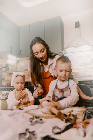 Family day, mom and kids baking in the kitchen. Christmas traditions highlighting the importance of...