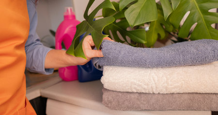 A stack of clean towels neatly folded. Home laundry with washing capsules - convenience and ease of use.の写真素材