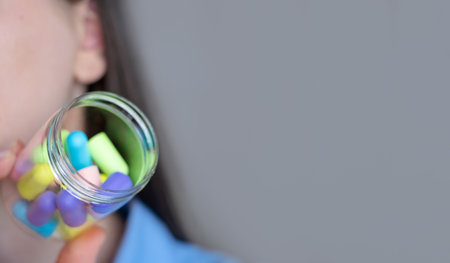 Woman holding a canister with many earplugs, gadgets for convenience - how earplugs help in daily...