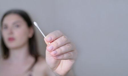 Body and sensory care concept, woman holding a cotton swab for ear cleaning, personal hygiene and...