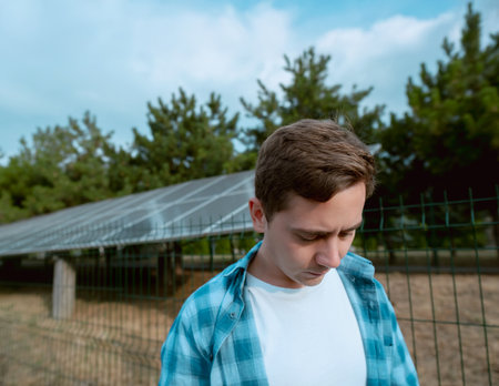 Electrician with renewable energy expertise connecting solar panels to electrical grids, ensuring efficient and safe integration.の写真素材