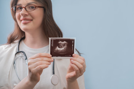 Obstetrician analyzes ultrasound image, guiding a woman towards a healthy and successful pregnancy journey.の写真素材
