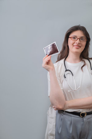 Female obstetrician-gynecologist provides detailed pregnancy planning advice based on ultrasound results.の写真素材