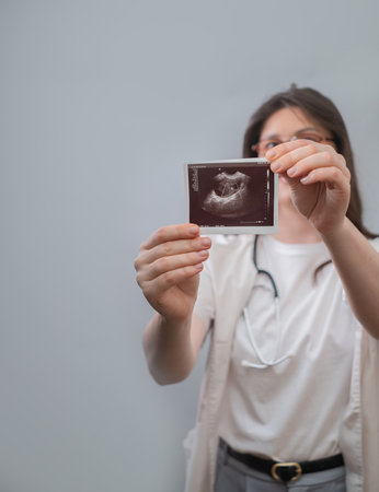 Obstetrician-gynecologist carefully examines ultrasound image to create a personalized treatment...
