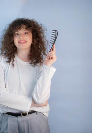 Painless detangling of curly hair with a comfortable brush designed for sensitive scalp and gentle daily hair care routineの写真素材
