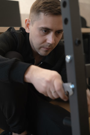 Man assembling furniture in apartment delivering quality and fast results with professional skills and care.の写真素材