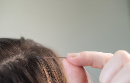 Close up of young woman with combined hair color after capsule extension procedure in beauty salon