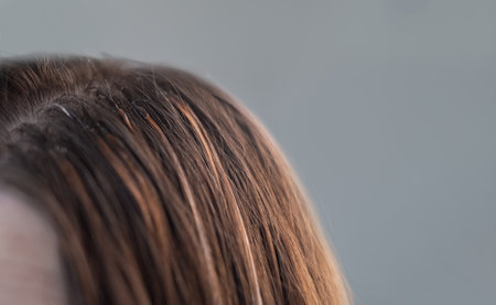Professional hair extension process with thin capsules hair care treatment in a beauty salon by skilled hairstylistの写真素材
