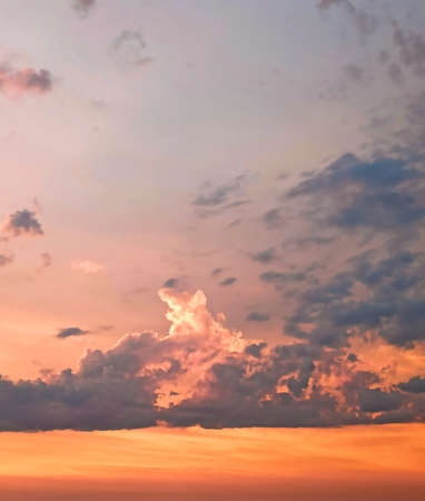 Against the background of the evening sunset sky colorful orange-purple dramatic clouds.の写真素材