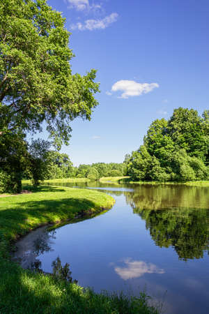 Landscape of a lake in a park with green trees. Printing for calendar, paintings, postcards.の写真素材