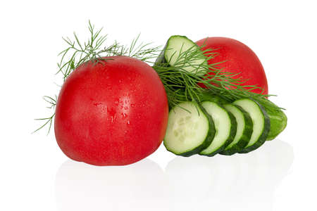 Isolated fresh vegetables. Sliced cucumbers and tomatoes with dill, salad components, isolated on a white background. For the design.の写真素材