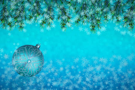 Defocus the blue background with bokeh, blue ball, snowflakes and Christmas tree twigs for the holidays. Copy space.の写真素材