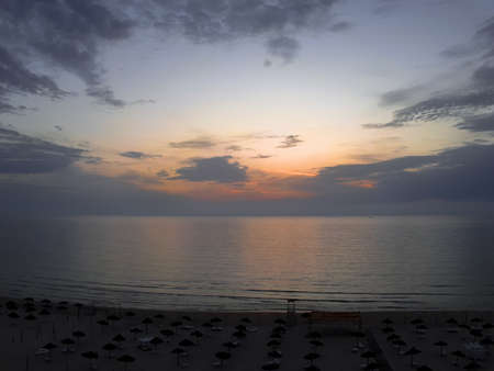 Sunrise on the water. Dawn on the sea beach. Screen saver, background.の写真素材