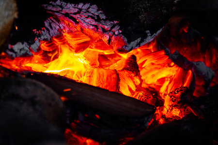 Embers, fire, flame, hearth. The concept of wood-burning heating, comfort and warmth.の写真素材