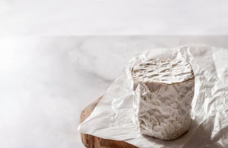 Homemade farm goat cheese on white beeswax wraps paper marble backgroundの写真素材