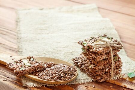 Healthy snack: cereal crunchy multigrain flax seed crispbread with dry zucchini vegetable on rustic...