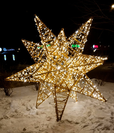 Christmas decoration in the form of a star on the street in winterの写真素材