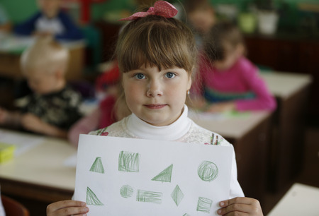 Belarus, the city of Gomel, May 16, 2016. Kindergarten Volotovskaya.Child girl holding figure with...