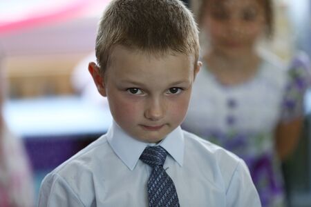 Belarus, Gomel, June 3, 2016 . Graduation in the kindergarten. The boy thinks.Diligent student. Serious preschooler. Smart primary school student.のeditorial素材