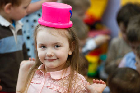 City Gomel, Belarus, April 13, 2017.Fifth kindergarten, graduation day.Girl with a bucket on her head.The child jokesのeditorial素材