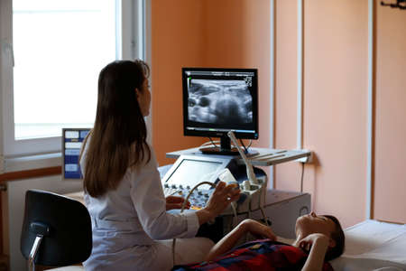 City of Gomel, Belarus 31 May 2017.Radiological medical center Ultrasonic diagnosis room.The doctor makes an ultrasonic diagnosis of the thyroid gland to an unknown guy.Ultrasound of the thyroid glandのeditorial素材