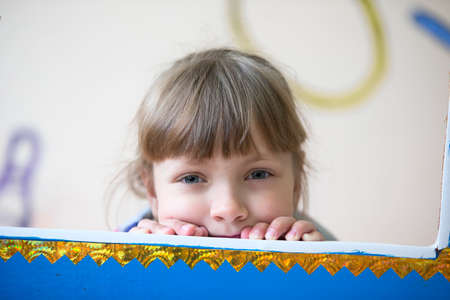 City of Gomel, Belarus April 28, 2017.Ivolsky kindergarten, graduation day.The girl looks out from...