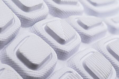 Fragment of a rubber white sole of a sneaker. Bottom of sports shoes