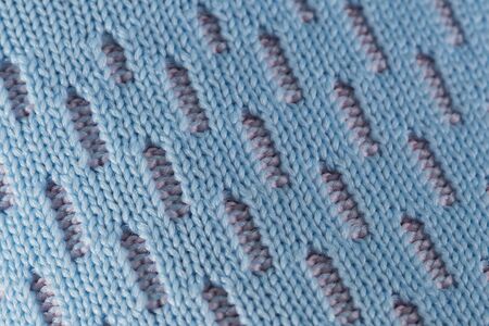 Fragment of a blue fabric sneaker. The texture of the material of sports shoes