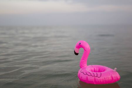 Pink flamingo inflatable on the background of the seaの写真素材