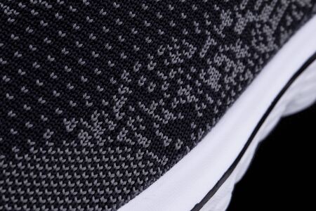 Fragment of a black sneaker with white sole close up. Sneaker textureの写真素材