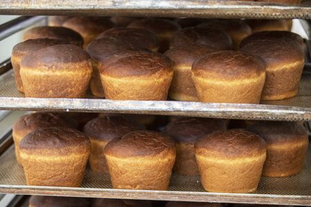 Industrial production of bread. Lots of baked goods on pallets. Freshly baked bun. Bakery
