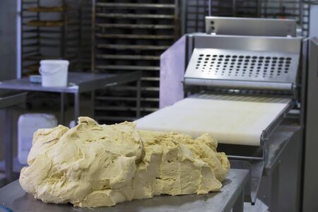 Industrial production of culinary products and bread.Yeast dough on the bread baking line
