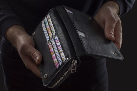 black purse in male handsの写真素材