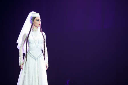 Belarus, Gomel, February 27, 2018. Concert hall. Speech of the national Georgian ballet Sukhishvili.A Georgian woman in a national white costume dances Georgian danceのeditorial素材