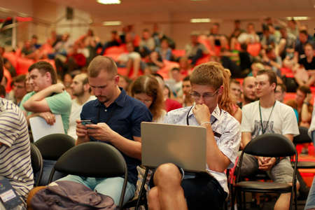 Belarus Minsk 05 August 2016 The Park of High Technologies. Competitions programmers.A group of young people with computers and telephones. A group of studentsのeditorial素材