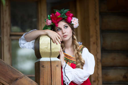 Russian beauty, emotional girl in traditional folk Russian costume and headdress adorable smiling and laughingのeditorial素材