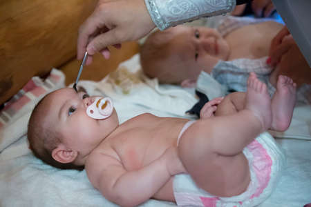 Belarus, the city of Gomel. June 10, 2017. Church at the regional hospital. The baptism of a child.The baby is smeared with incense at the rite of baptismのeditorial素材