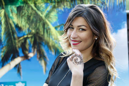 Belarus, the city of Gomel, June 15, 2017. Chabarok restaurant, birthday celebration project new style.Brunette with tattoo on hand on tropical background.Tropical beauty. Italian womanのeditorial素材