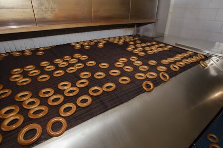 Industrial production of bagel bakery products. Barankin baking conveyor line.Bakery
